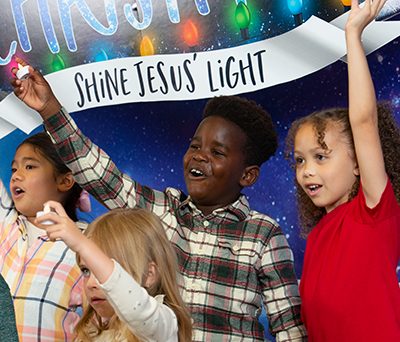 Several kids cheering and dancing with Stellar Christmas logo in the background