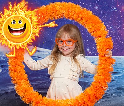 Girl holding a orange hula-hoop with Sol the Bible Memory Buddy