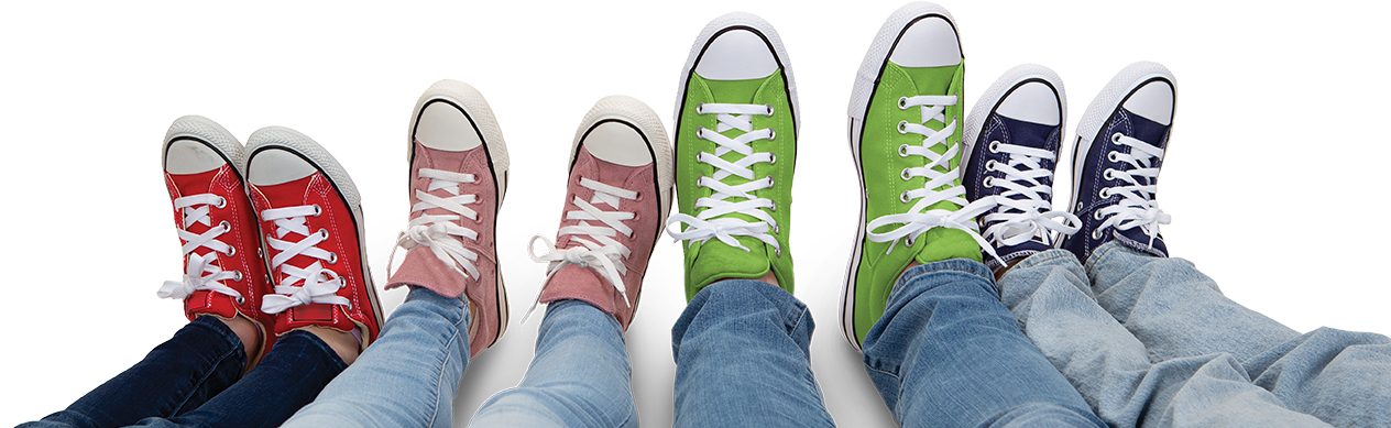 family of four laying down with sneakers on