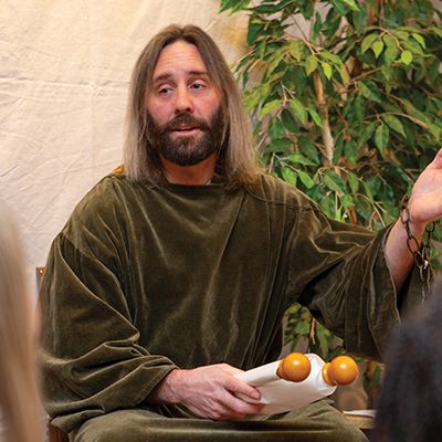 VBS volunteer dressed like Paul in a robe