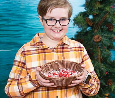 Boy with glasses holding a basket
