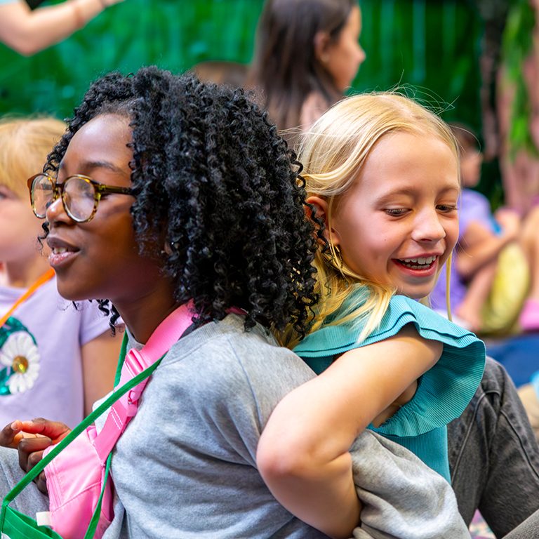 Girls at VBS stadning back to back